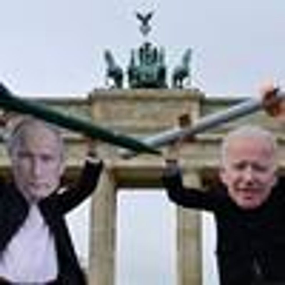 Peace activists wearing masks of Russian President Vladimir Putin (L) and U.S. President Joe Biden pose with mock nuclear missiles in front of Berlin's landmark Brandenburg Gate on January 29, 2021 in an action to call for more progress in nuclear disarmament. (Photo: John Macdougall/AFP via Getty Images)