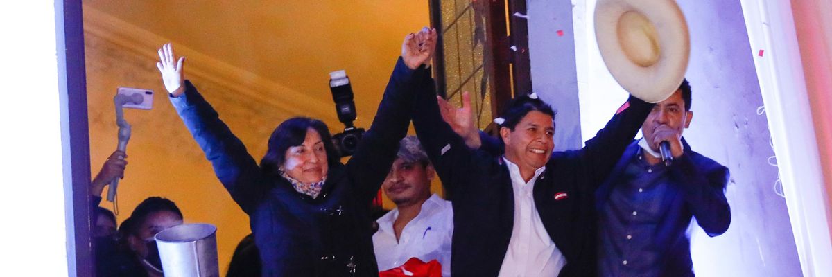 Pedro Castillo, the president-elect of Peru, and his running mate Dina Boluarte, wave to supporters during a celebration following the official announcement of their victory on July 19, 2021 in Lima, Peru. (Photo: Ricardo Moreira via Getty Images)