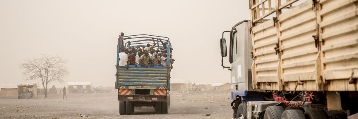 People are loaded into trucks to take them from Joda, on the...