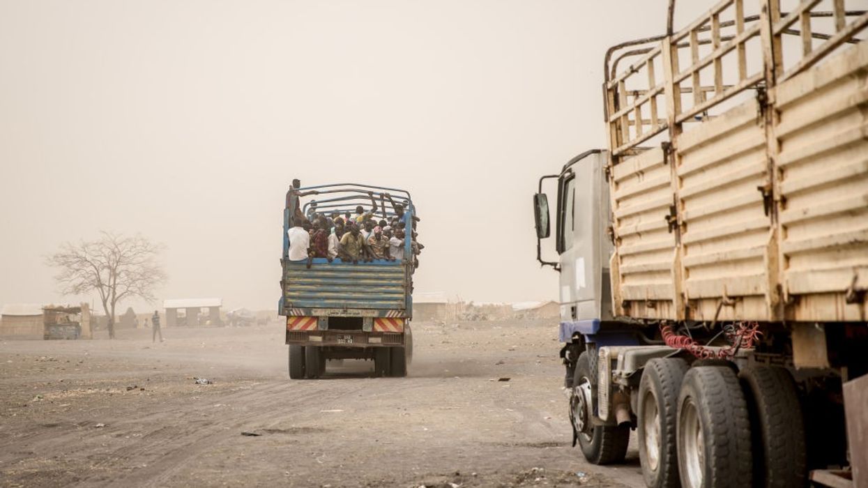 People are loaded into trucks to take them from Joda, on the...