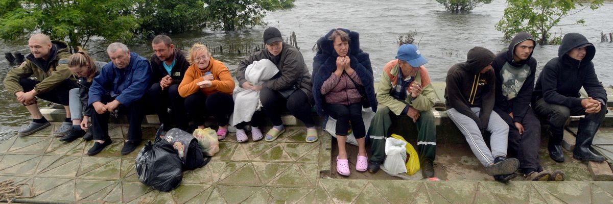 People are pictured in Afanasiyivka, Mykolaiv region on June 12, 2023 after the Kakhovka dam collapse.