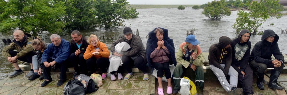 People are pictured in Afanasiyivka, Mykolaiv region on June 12, 2023 after the Kakhovka dam collapse. 