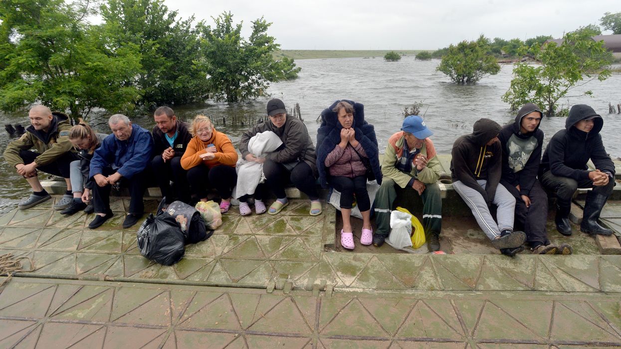 People are pictured in Afanasiyivka, Mykolaiv region on June 12, 2023 after the Kakhovka dam collapse.