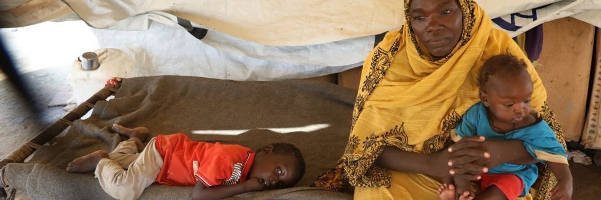 People are seen in a tent at a center for displaced people fleeing from conflict