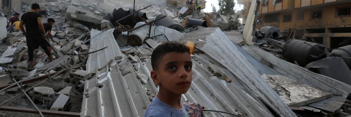 People assess the destruction caused by Israeli airstrikes