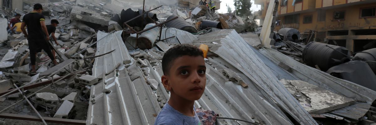 People assess the destruction caused by Israeli airstrikes