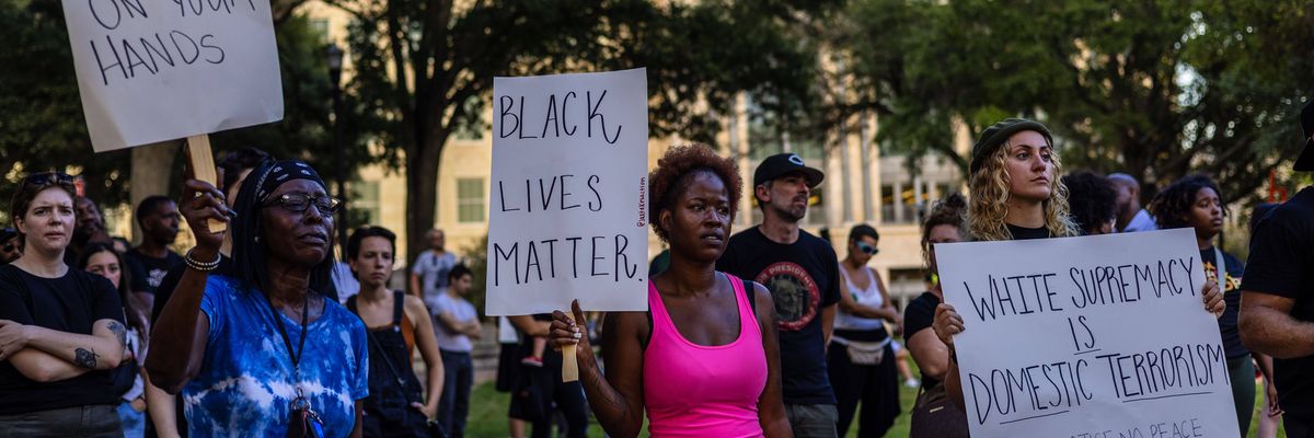 People attend a rally at James Weldon Johnson Park