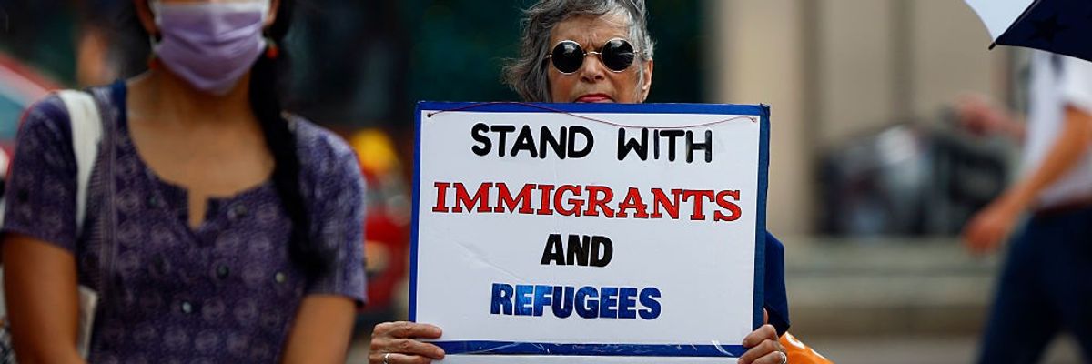People attend a rally in solidarity with Temporary Protected Status holders from Honduras, Nepal, and Nicaragua