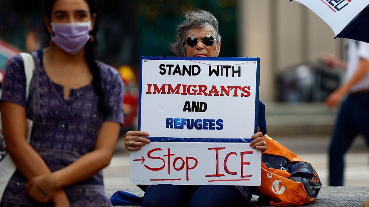 People attend a rally in solidarity with Temporary Protected Status holders from Honduras, Nepal, and Nicaragua