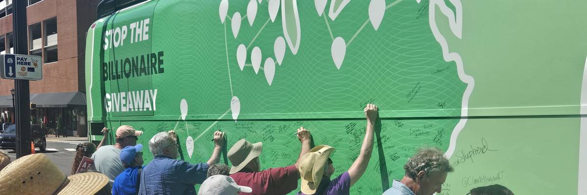 People attend the “Stop the Billionaire Tax Giveaway" bus tour.