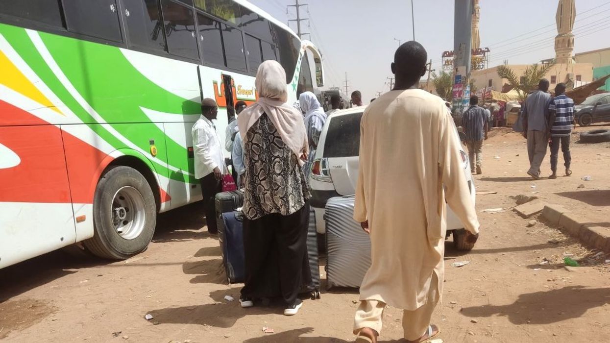 People board a bus.