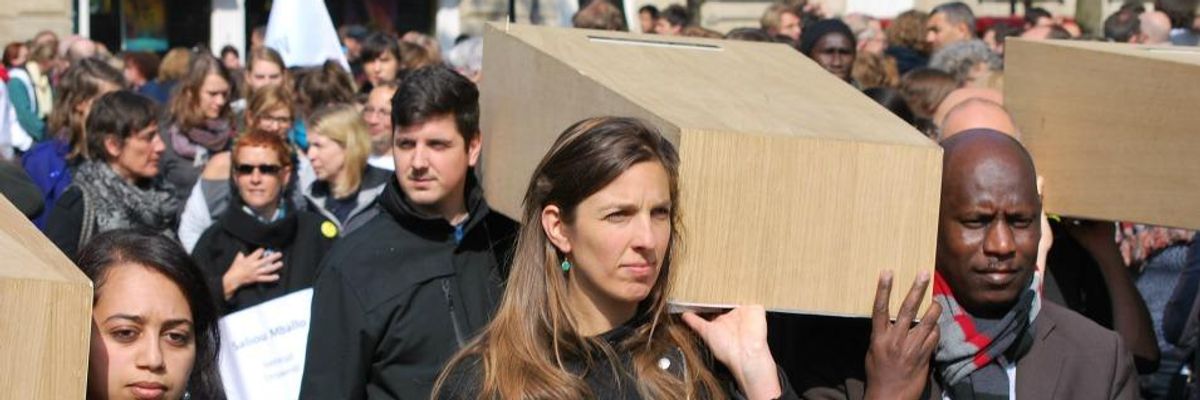 People carry coffins to protest EU migration policies.