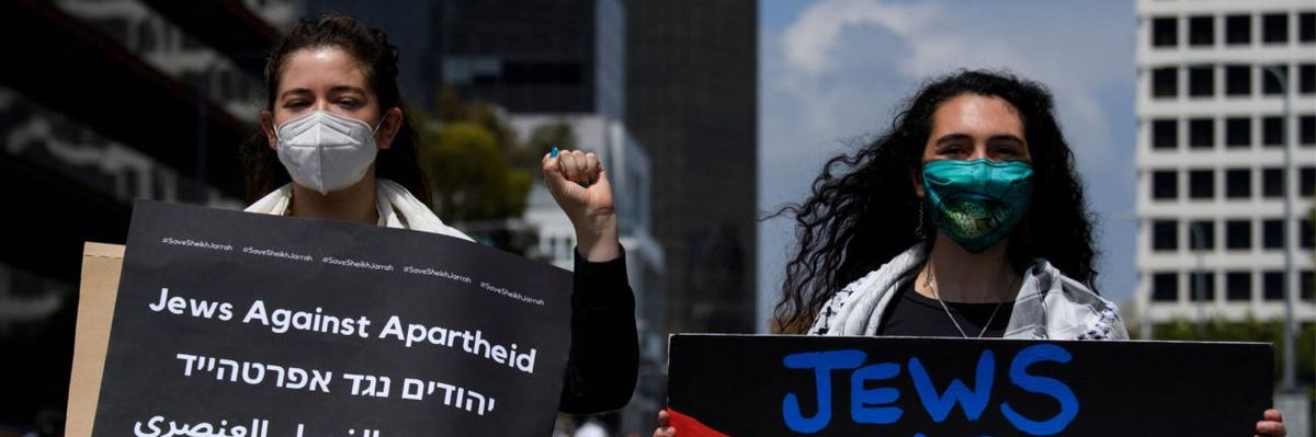 People carry signs reading "Jews Against Apartheid" during the Los Angeles Nakba 73: Resistance Until Liberation rally.