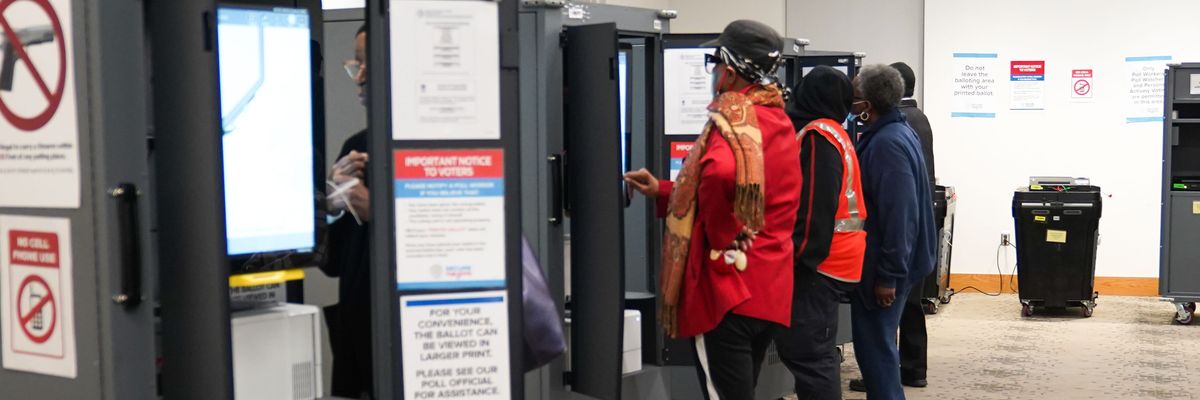 People cast their votes on the first day of early voting in Georgia