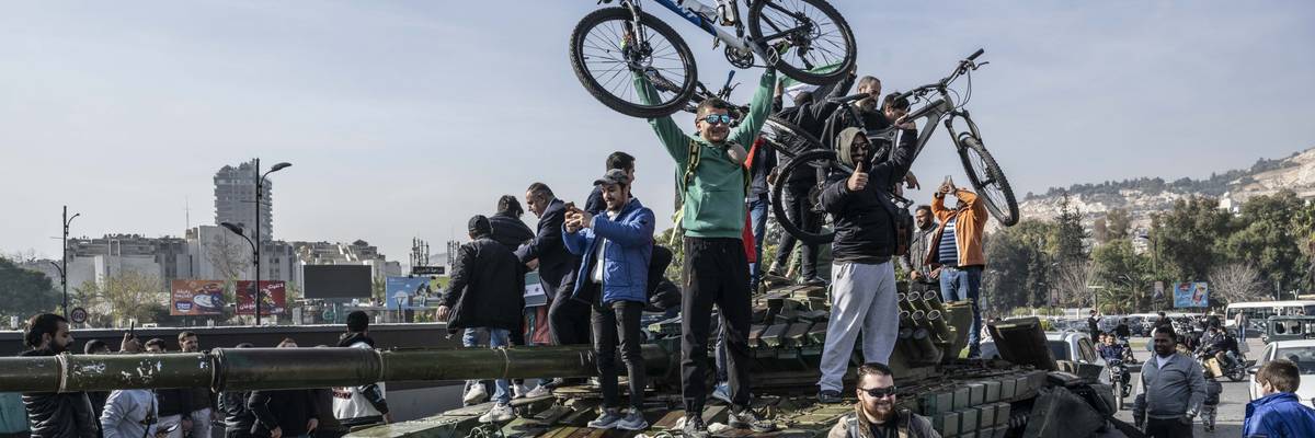 People celebrate Assad's fall in Syria.