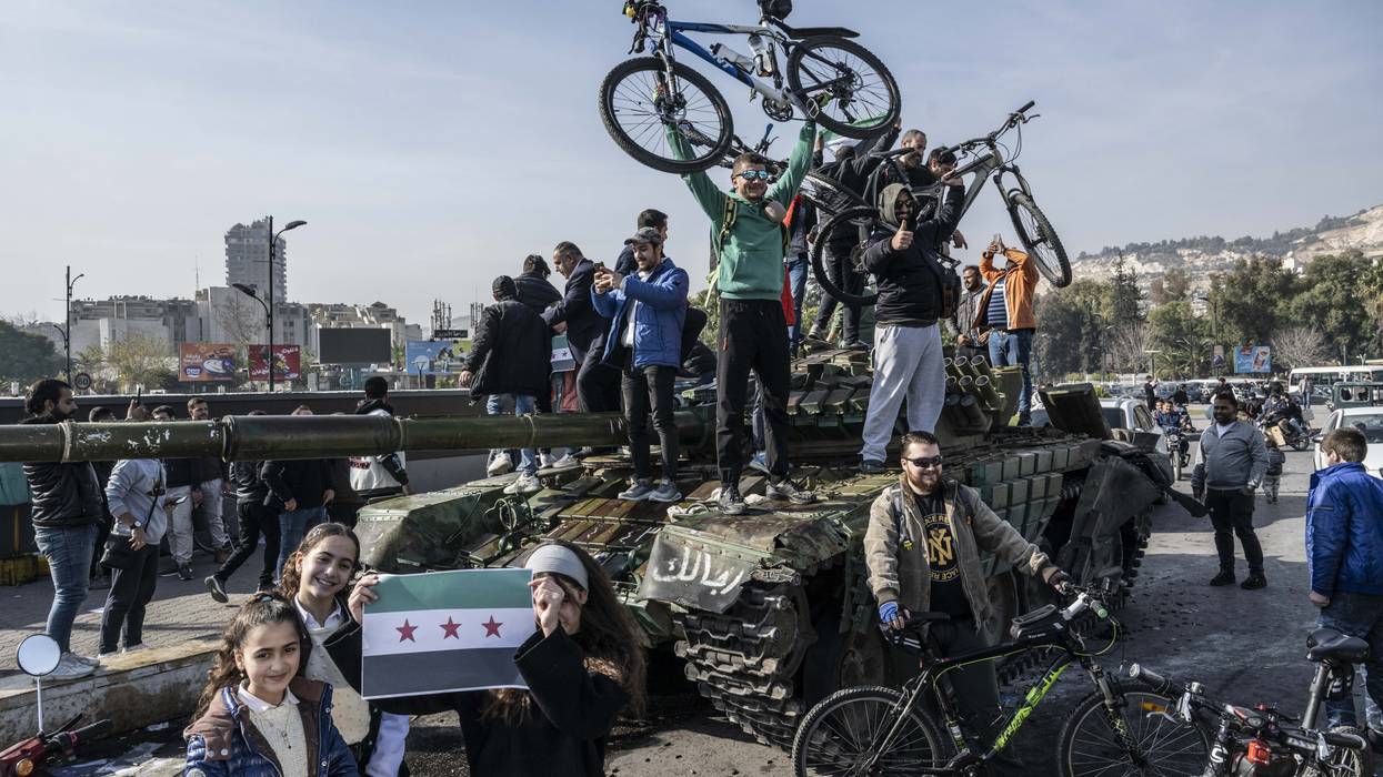 People celebrate Assad's fall in Syria.