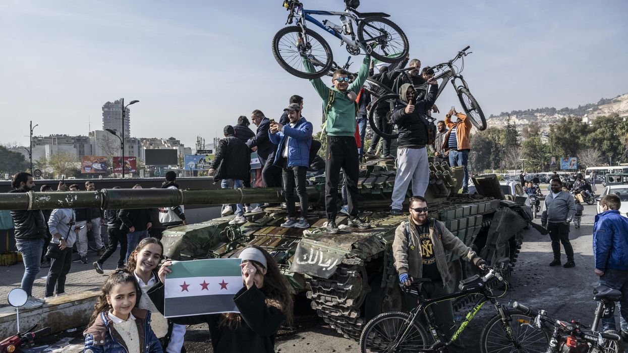 People celebrate Assad's fall in Syria.