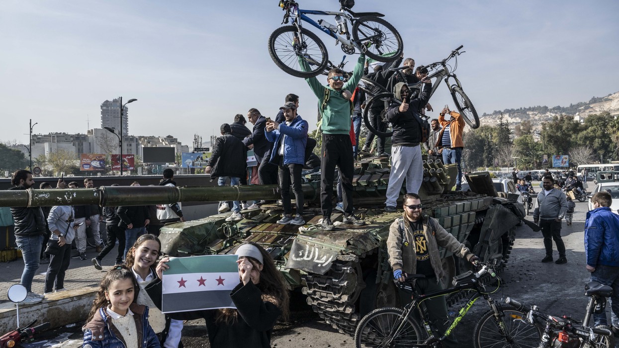 People celebrate Assad's fall in Syria.