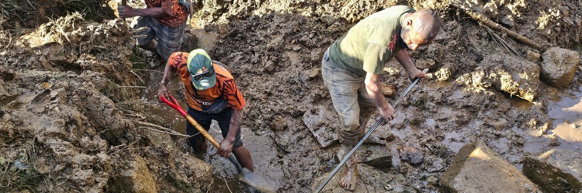 People dig through rubble of PNG landslide.