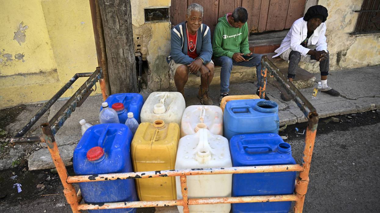 People fill water containers in Havana