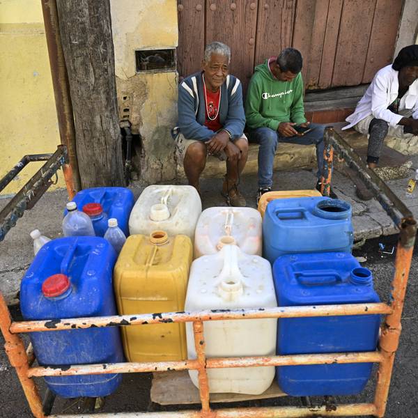 People fill water containers in Havana