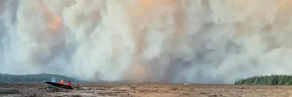 People flee wildfires in motor boat.
