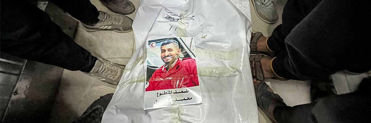 People gather around the body of Palestinian paramedic Mohamed Bahloul