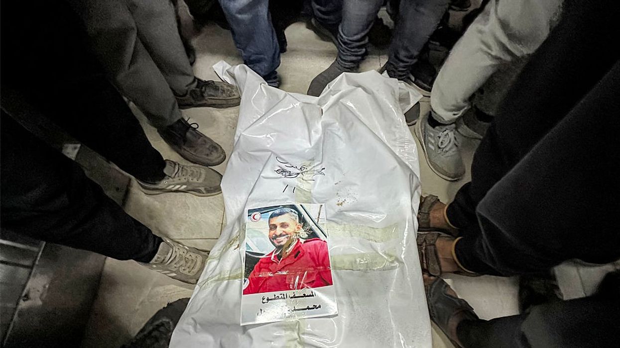 People gather around the body of Palestinian paramedic Mohamed Bahloul