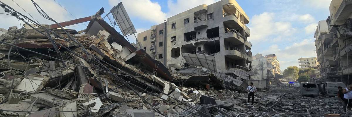 People gather at the site of an Israeli strike that hit near a hospital in the southern Lebanese city of Tyre