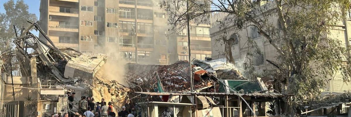 People gather at the site of the bombed Iranian consulate in Damascus