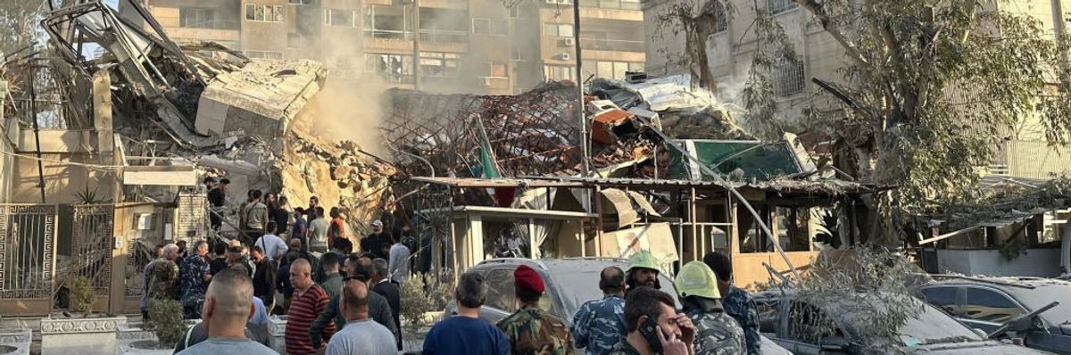 People gather at the site of the bombed Iranian consulate in Damascus