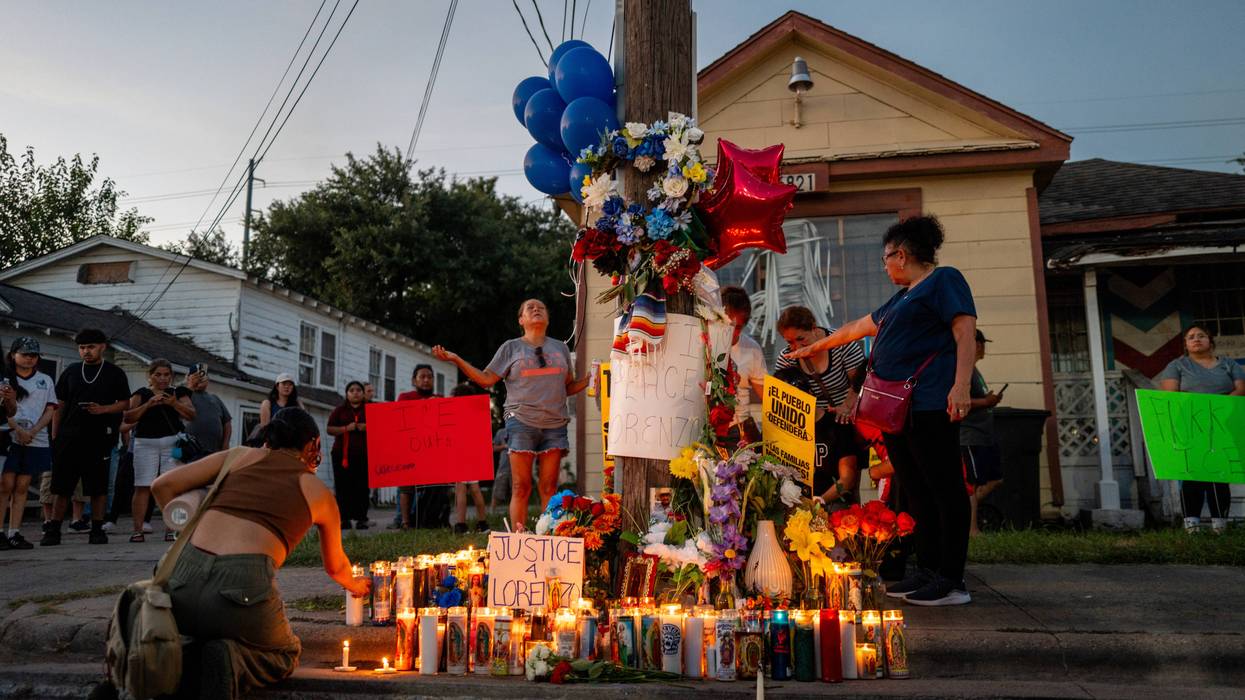 People grieve at a makeshift candlelight memorial to Lorenzo Salgado