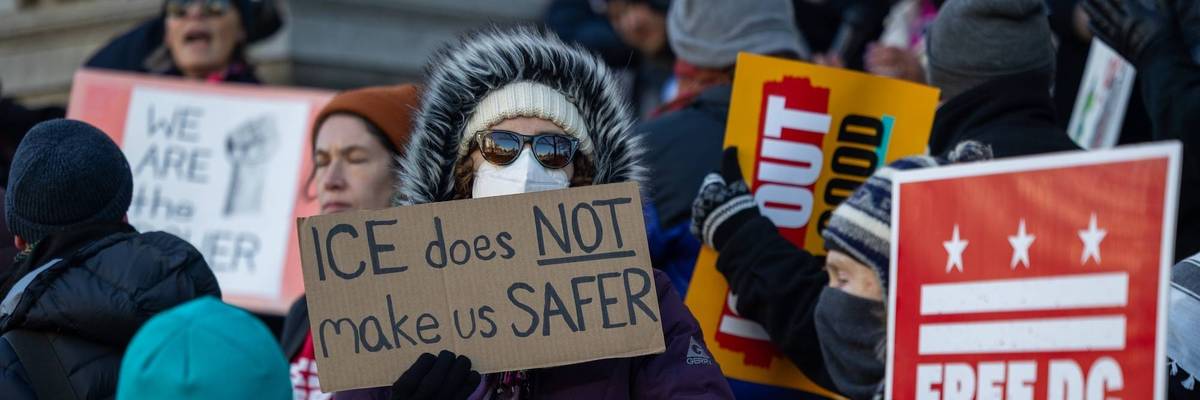 People hold a rally against ICE in Washington Dc
