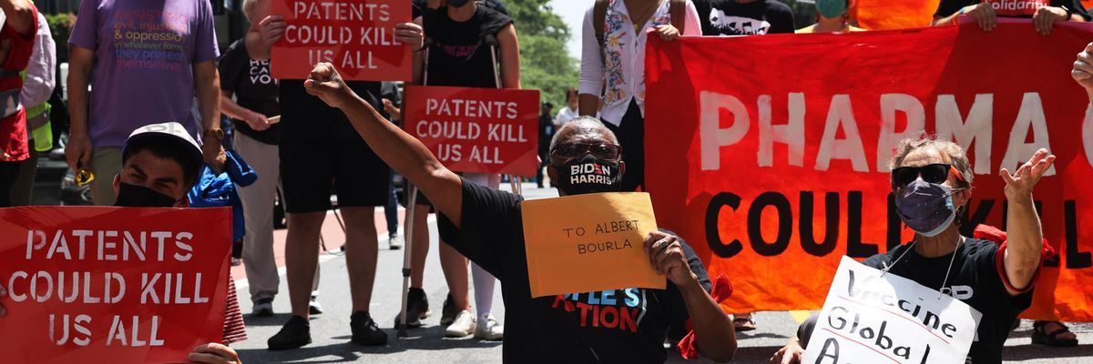 People hold a sit-in during a protest to demand German Chancellor Angela Merkel and Pfizer make Covid-19 vaccines and treatments more accessible outside the pharmaceutical company's headquarters on July 14, 2021 in New York City. (Photo: Michael M. Santiago via Getty Images)