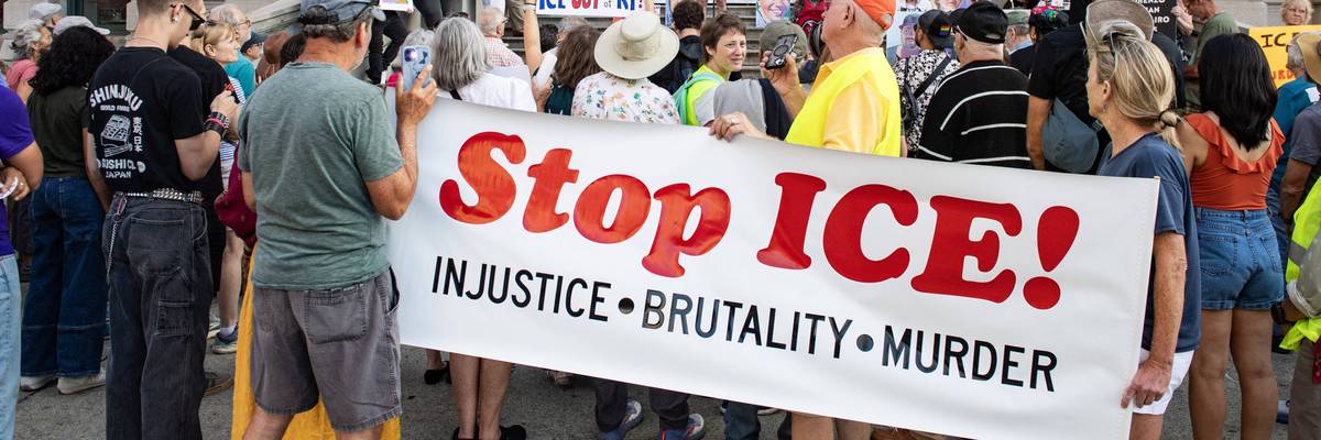 People hold a "Stop ICE" banner in Providence, Rhode Islnd