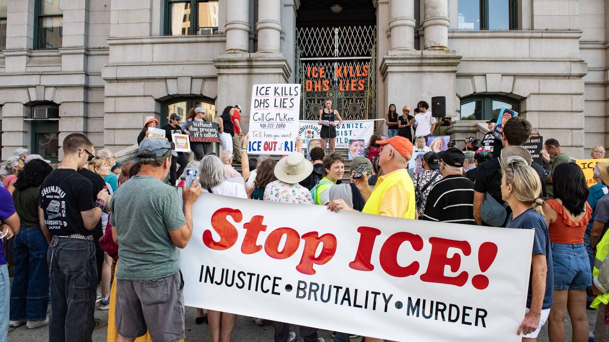 People hold a "Stop ICE" banner in Providence, Rhode Islnd