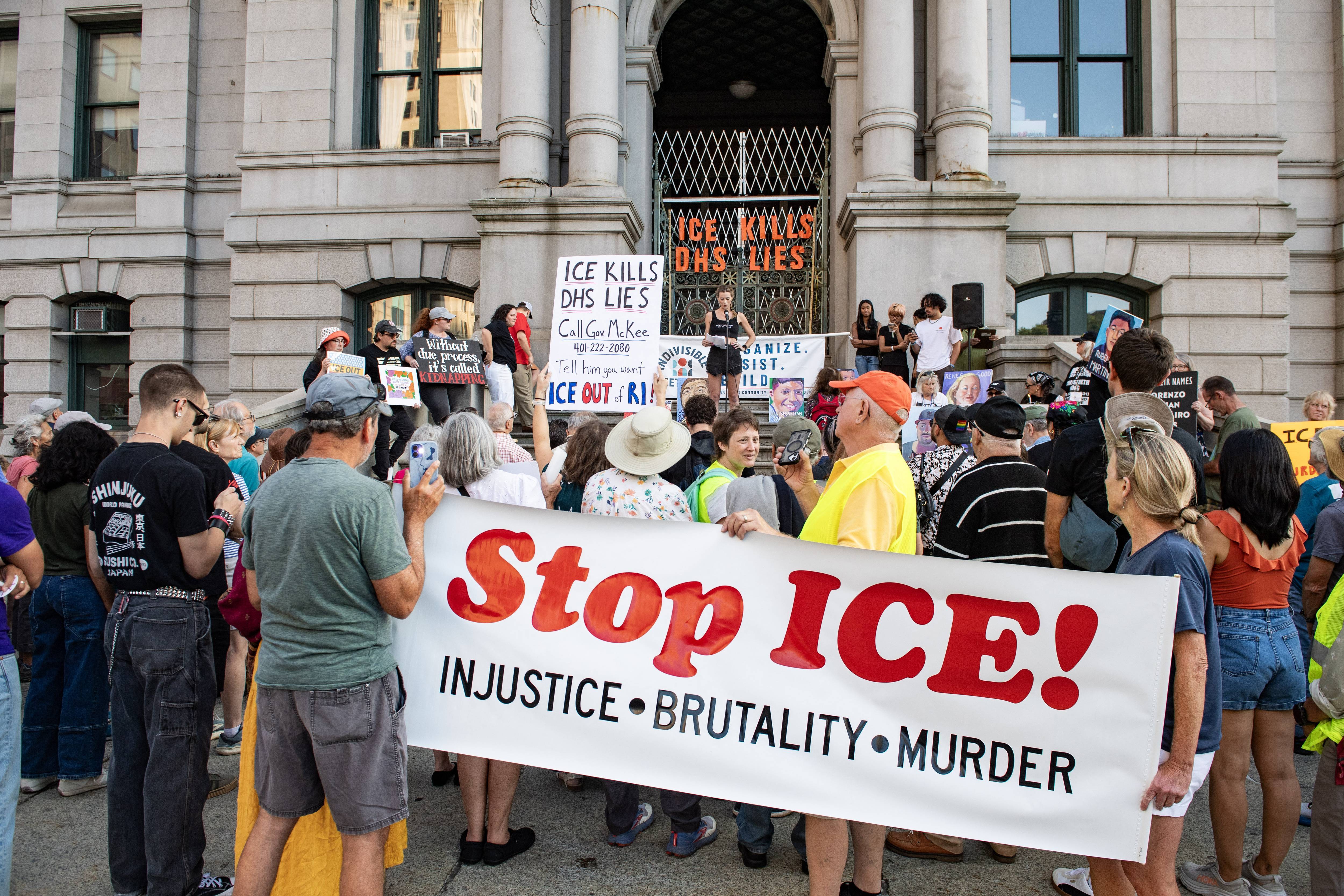 People hold a "Stop ICE" banner in Providence, Rhode Islnd