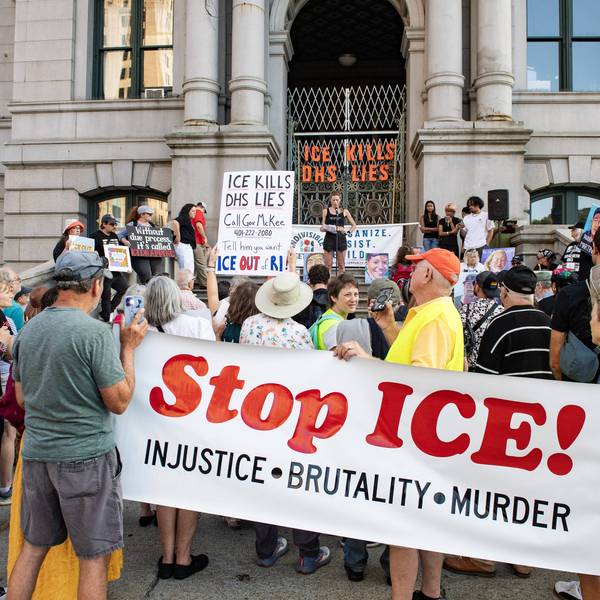 People hold a "Stop ICE" banner in Providence, Rhode Islnd