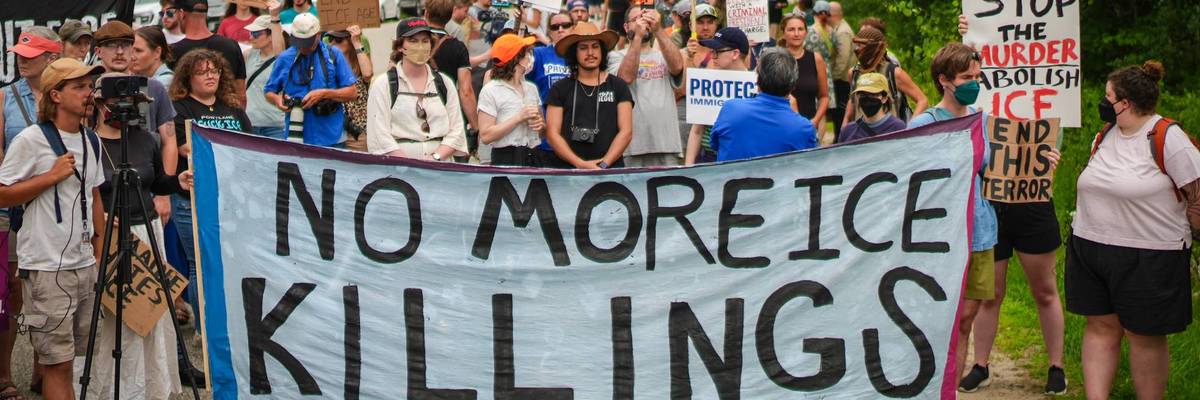People hold banner reading, "No more ICE killings."
