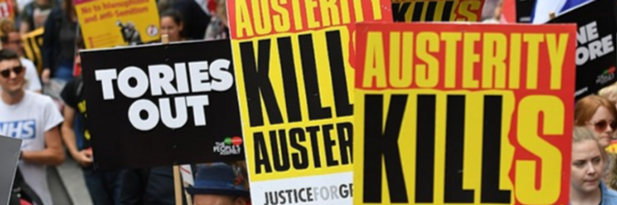 People hold placards reading 'Austerity Kills'