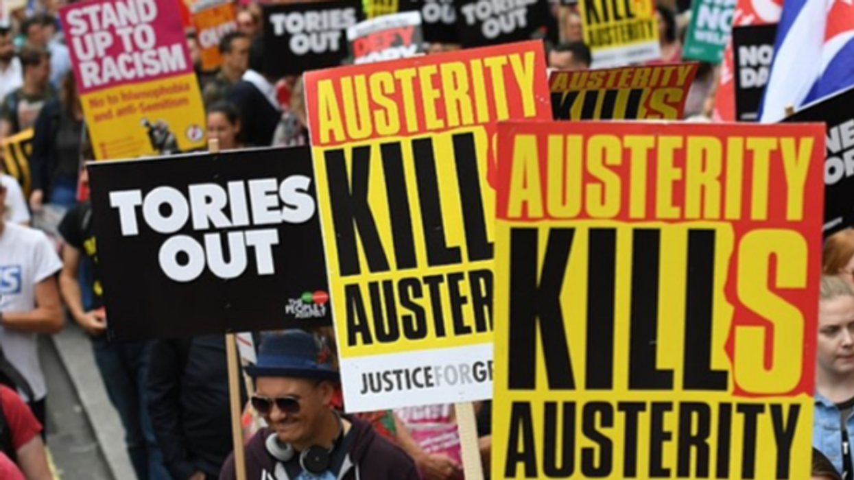 People hold placards reading 'Austerity Kills'