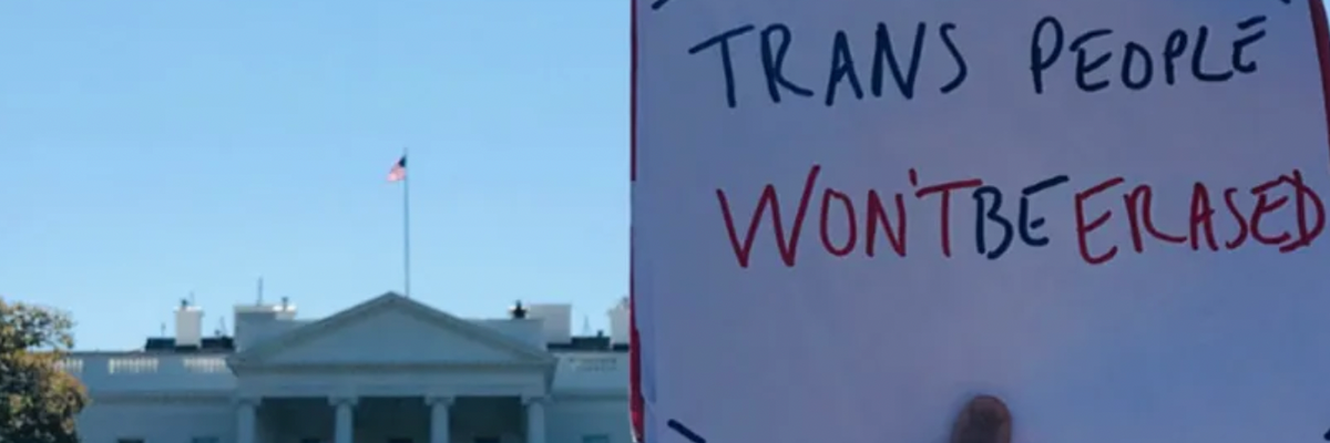 People hold signs at a protest for transgender rights in Washington, D.C. 