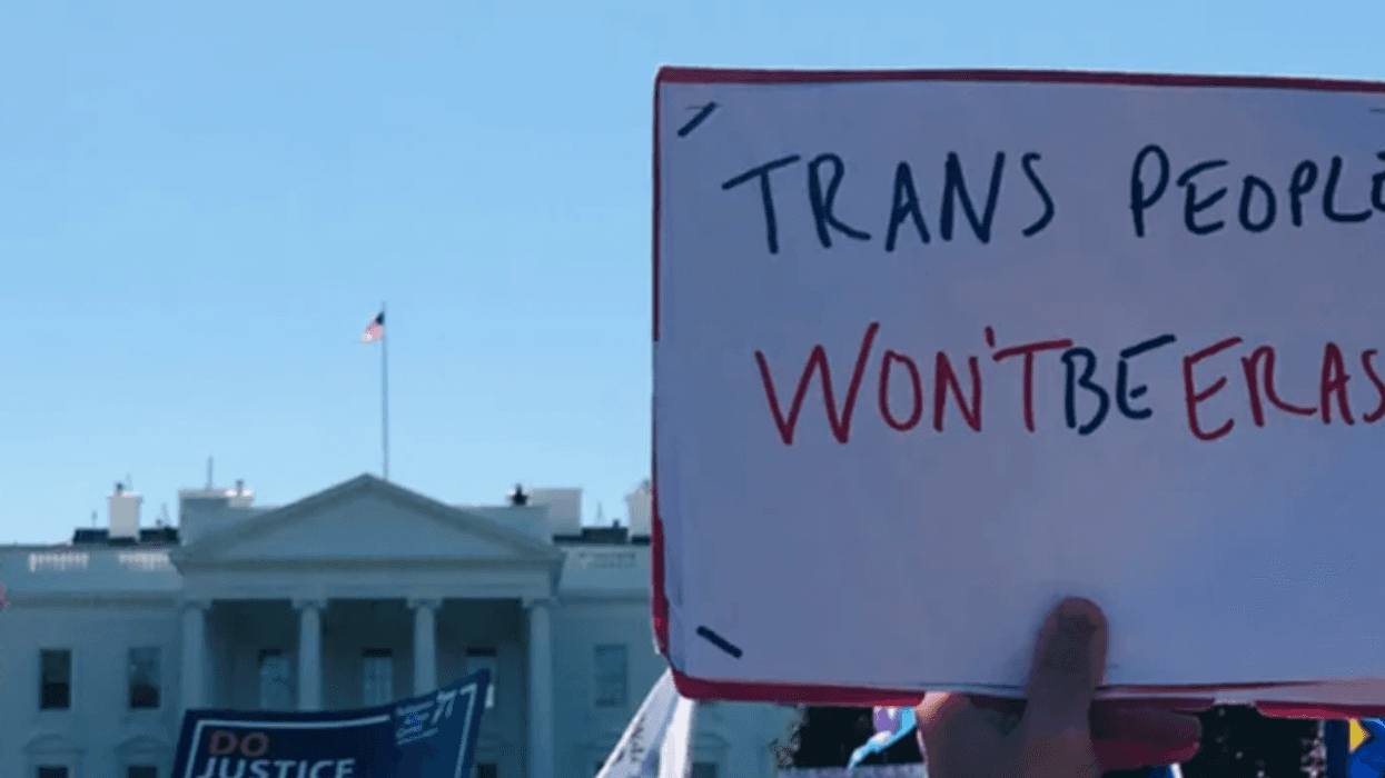 People hold signs at a protest for transgender rights in Washington, D.C.