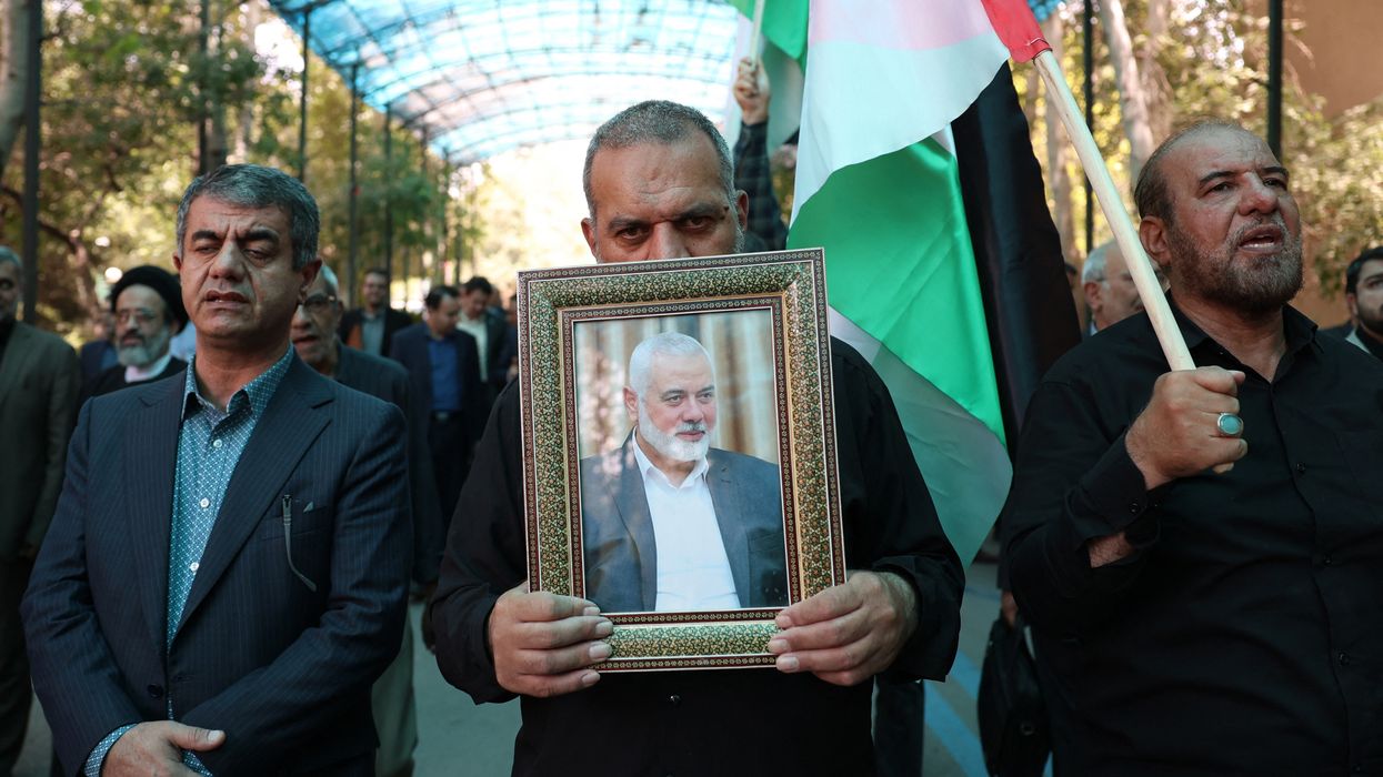 People hold up a portrait of assassinated Hamas political chief Ismail Haniyeh