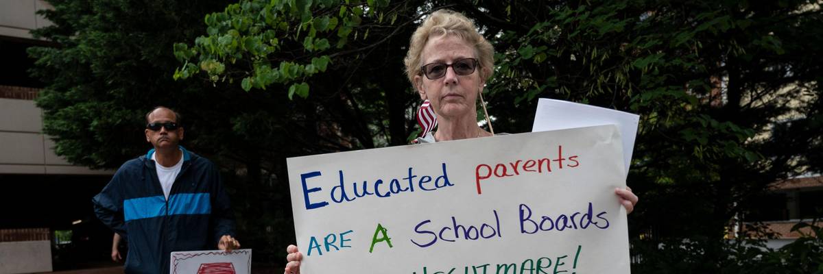 People hold up signs during a rally against "Critical Race Theory" (CRT) being taught in schools at the Loudoun County Government Center in Leesburg, Virginia on June 12, 2021. (Photo: Andrew Caballero-Reynolds/AFP via Getty Images)