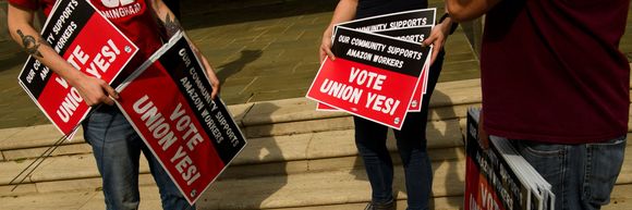People hold "Vote Union Yes!" signs