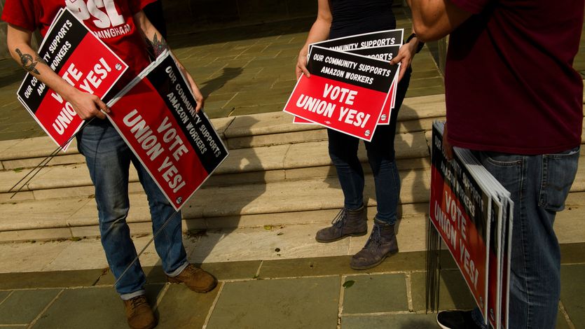 People hold "Vote Union Yes!" signs