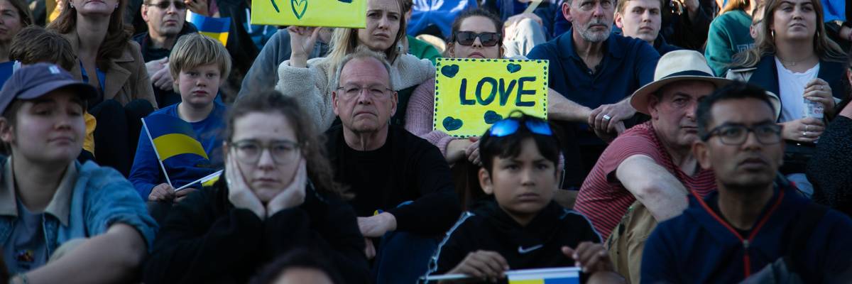 People holding signs of "Peace" and "Love" at London rally