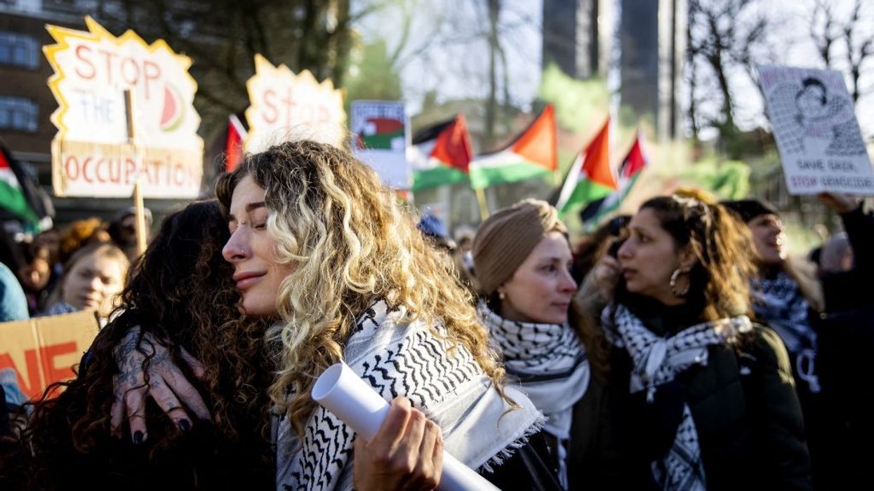 People hug outside the ICJ after ruling on January 26, 2024