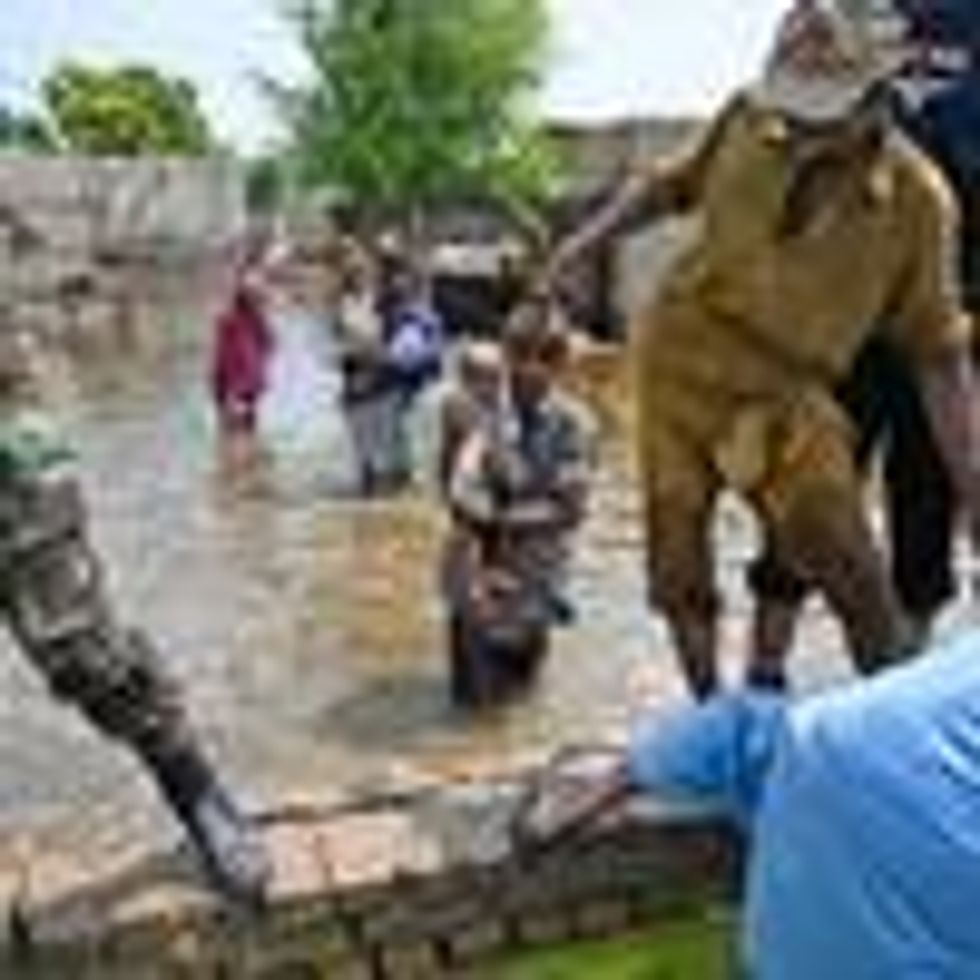 People impacted by flooding in Pakistan flee their damaged homes